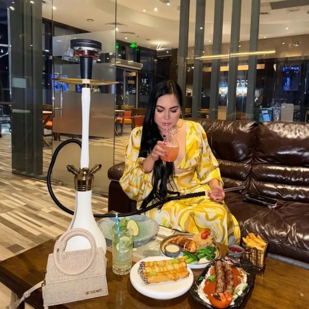 lady-in-yellow-dress-enjoying-food-and-shisha-at-Jasmira
